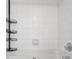 Clean white tiled shower area with storage shelves and modern fixtures at 2700 Pine Tree Ne Rd # 2306, Atlanta, GA 30324
