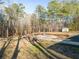 Wooded backyard with a storage shed and fenced area at 2715 County Line Nw Rd, Acworth, GA 30101