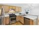 Kitchen with stainless steel appliances and light wood cabinets at 322 Ravinia Way, Lawrenceville, GA 30044