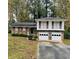 Brick ranch home with attached two-car garage and mature landscaping at 1482 Indian Forest Trl, Stone Mountain, GA 30083