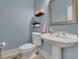 Clean bathroom with pedestal sink and updated toilet at 1422 Hillside Dr, Grayson, GA 30017