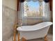 Elegant bathroom featuring a clawfoot tub and gold fixtures at 1422 Hillside Dr, Grayson, GA 30017