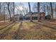 House back view, showcasing large deck and wooded area at 1422 Hillside Dr, Grayson, GA 30017