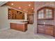 Kitchen with wood cabinets, island, and brick feature wall at 1422 Hillside Dr, Grayson, GA 30017