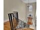 Elegant staircase with wrought iron railing and hardwood floors at 1422 Hillside Dr, Grayson, GA 30017