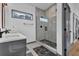 Sleek bathroom design with a glass-enclosed shower showcasing patterned tile, a gray vanity, and a modern aesthetic at 1822 Avon Sw Ave, Atlanta, GA 30311