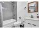 Cozy bathroom with a tub-shower combo, gray tiled walls, a modern toilet, and a vanity with white marble countertop at 1822 Avon Sw Ave, Atlanta, GA 30311