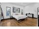 Bright bedroom with hardwood floors, a comfortable bed, and large windows at 1822 Avon Sw Ave, Atlanta, GA 30311