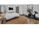 Light-filled bedroom featuring hardwood floors and Peloton bike at 1822 Avon Sw Ave, Atlanta, GA 30311