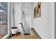 Bright hallway featuring hardwood floors, modern art, large window, and an indoor tree at 1822 Avon Sw Ave, Atlanta, GA 30311