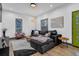 Living room with sectional sofa, hardwood floors, and modern decor at 1822 Avon Sw Ave, Atlanta, GA 30311