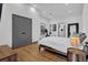 Spacious main bedroom with wood floors, neutral colors, and natural light, with a view to the ensuite bathroom at 1822 Avon Sw Ave, Atlanta, GA 30311