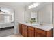 Double vanity bathroom with wood cabinets and quartz countertops at 3164 Sw Wolf Club Sw Dr, Atlanta, GA 30349