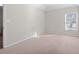 Bright bedroom with neutral walls and carpeting; window with natural light at 3164 Sw Wolf Club Sw Dr, Atlanta, GA 30349