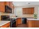 Kitchen with corner sink, black appliances, and light countertops at 3164 Sw Wolf Club Sw Dr, Atlanta, GA 30349