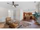 Living room with hardwood floors, fireplace and kitchen view at 3164 Sw Wolf Club Sw Dr, Atlanta, GA 30349