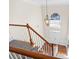 Elegant staircase with wood railing and carpet runner, overlooking the grand foyer at 3164 Sw Wolf Club Sw Dr, Atlanta, GA 30349