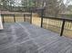 Wooden back deck with black metal railings overlooking a fenced backyard and mature trees at 4019 Kingsbrook Blvd, Decatur, GA 30034