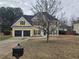 Charming two-story home with a well-maintained lawn and a two-car garage on a cloudy day at 4019 Kingsbrook Blvd, Decatur, GA 30034