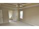 Spacious main bedroom showcasing a ceiling fan, carpet floors and an ensuite bathroom at 4019 Kingsbrook Blvd, Decatur, GA 30034