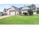 Tan brick house with white garage door and neatly landscaped yard at 559 Ransom Way, Stockbridge, GA 30281