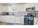 Modern kitchen with white cabinets, stainless steel appliances, and tile backsplash at 559 Ransom Way, Stockbridge, GA 30281