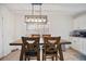 Bright kitchen features white cabinets, stainless steel appliances, and wood dining table at 559 Ransom Way, Stockbridge, GA 30281