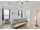 Main bedroom with ceiling fan and view into bathroom at 559 Ransom Way, Stockbridge, GA 30281