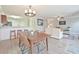 Bright dining area with wood table and chairs, open to kitchen and living room at 125 Hidden Creek Dr, Canton, GA 30114