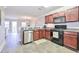 Kitchen with dark wood cabinets, granite countertops and stainless steel appliances at 125 Hidden Creek Dr, Canton, GA 30114