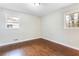 Well-lit bedroom featuring hardwood floors and two windows at 1730 Carla Dr, Morrow, GA 30260