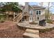 Stone patio with fire pit, deck, and stairs leading to backyard at 2085 Melrose Trce, Cumming, GA 30041