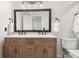 Modern bathroom with a double vanity and a light wood cabinet at 2085 Melrose Trce, Cumming, GA 30041