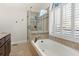 Bathroom with a soaking tub, walk-in shower, and neutral tile at 2085 Melrose Trce, Cumming, GA 30041