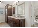 Elegant bathroom with double vanity, granite countertop, and large mirror at 2085 Melrose Trce, Cumming, GA 30041