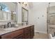 Bathroom with double vanity, granite countertop and large mirror at 2085 Melrose Trce, Cumming, GA 30041