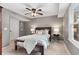 Well-lit bedroom with wooden bed frame, ceiling fan, and carpet at 2085 Melrose Trce, Cumming, GA 30041