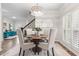 Bright dining room with a round table and four chairs, hardwood floors, and a view to living room at 2085 Melrose Trce, Cumming, GA 30041