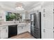 Modern kitchen with white cabinets, stainless steel appliances, and farmhouse sink at 2085 Melrose Trce, Cumming, GA 30041