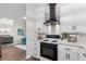 Modern kitchen with white cabinets, black appliances, and granite countertops at 2085 Melrose Trce, Cumming, GA 30041