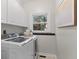 Bright laundry room with white cabinets and modern washer and dryer at 2085 Melrose Trce, Cumming, GA 30041