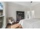 Main bedroom with hardwood floors, large window, and a sitting area with a chair at 2085 Melrose Trce, Cumming, GA 30041