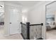 Upper hallway with plush carpeting, white doors, and an ornate railing at 2085 Melrose Trce, Cumming, GA 30041