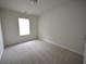 Bright bedroom with neutral walls and carpeted floor at 3284 Pennington Dr, Lithonia, GA 30038