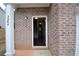 Brick front entryway with open door revealing hardwood floors at 3284 Pennington Dr, Lithonia, GA 30038