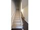 Staircase with carpeted steps and dark wood railing at 3284 Pennington Dr, Lithonia, GA 30038