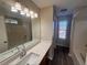 Bathroom featuring a vanity with a large mirror, and a shower-tub combination at 7645 Broadhurst Dr, Riverdale, GA 30296