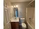 Cozy bathroom with vanity sink, framed mirror, and standard toilet and tub at 7645 Broadhurst Dr, Riverdale, GA 30296