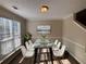 Dining room with modern table set, window and contemporary chandelier at 7645 Broadhurst Dr, Riverdale, GA 30296