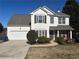 Two-story house with gray roof, white siding, and landscaping at 7645 Broadhurst Dr, Riverdale, GA 30296